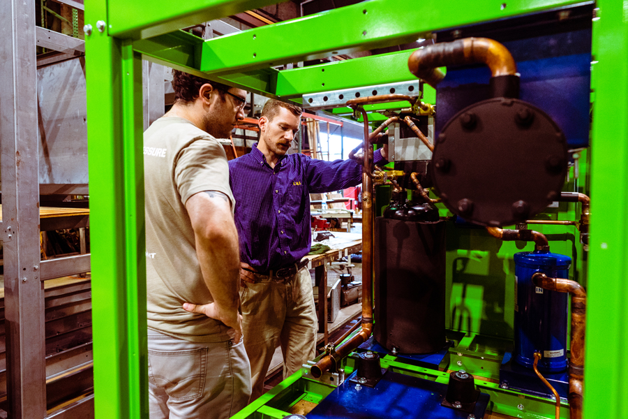 Scientific Systems Team Inspecting Equipment